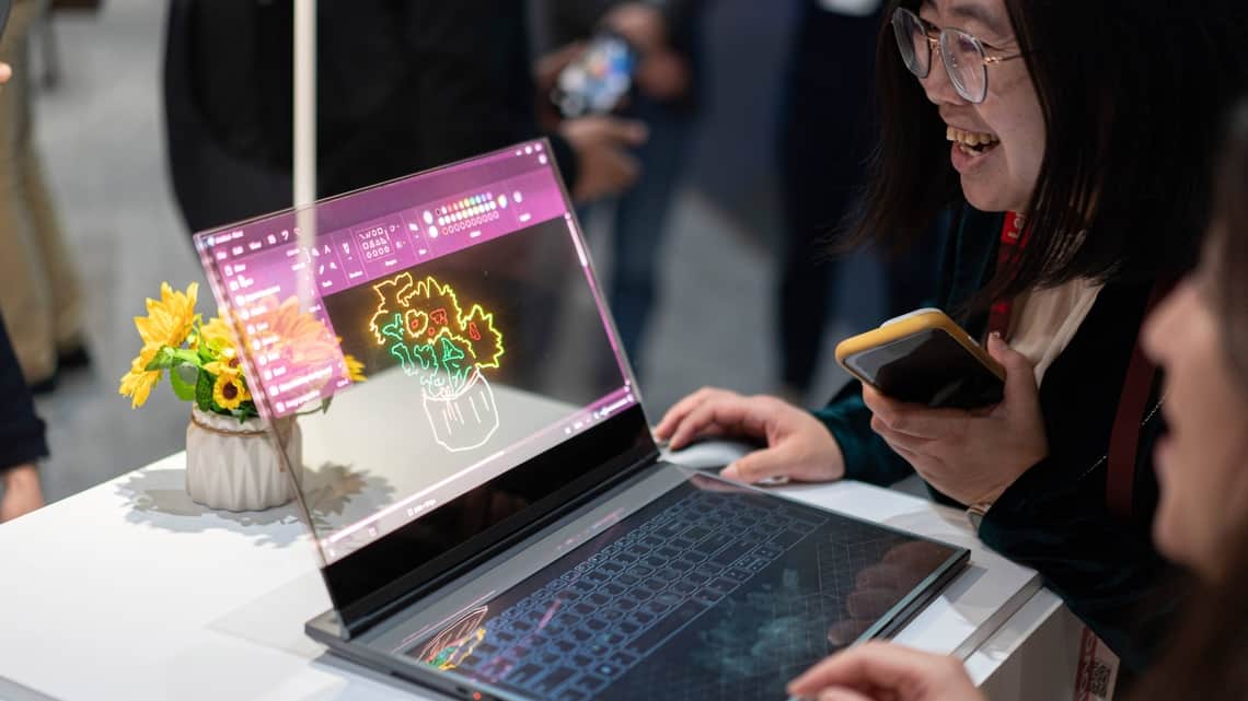 Visitors test the Lenovo Thinkbook Transparent Display Laptop Concept during the third day of the Mobile World Congress 2024 in Barcelona, Spain, Wednesday, Feb. 28, 2024.
