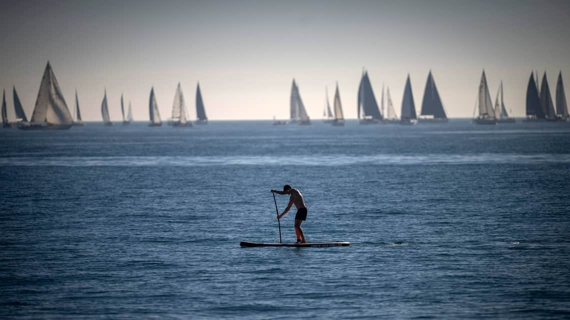 FILE - A man paddles in the Mediterranean Sea in Barcelona, Spain, Feb. 4, 2024. Earth has exceeded global heat records in February, according to the European Union climate agency Copernicus.