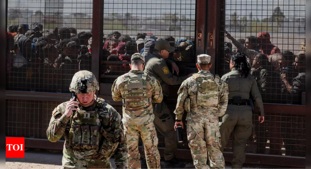 Texas border clash: Migrants overcome guards, break through security barrier - Times of India