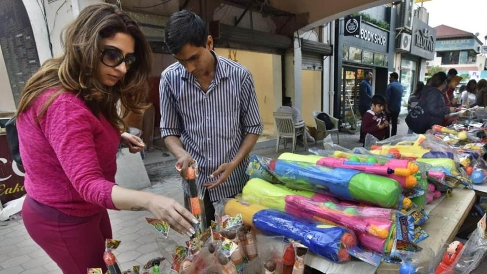 Tourists join Holi frenzy: Delhi markets abuzz with last-minute shoppers for colours, water guns and political masks