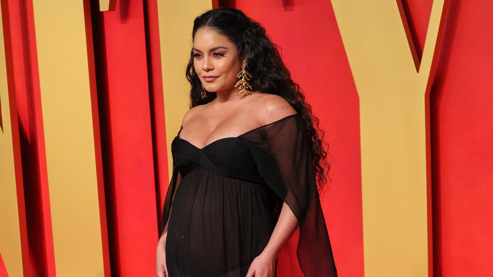 Vanessa Hudgens shows off her baby bump in see-through gown at Vanity Fair Oscars Party red carpet. All pics