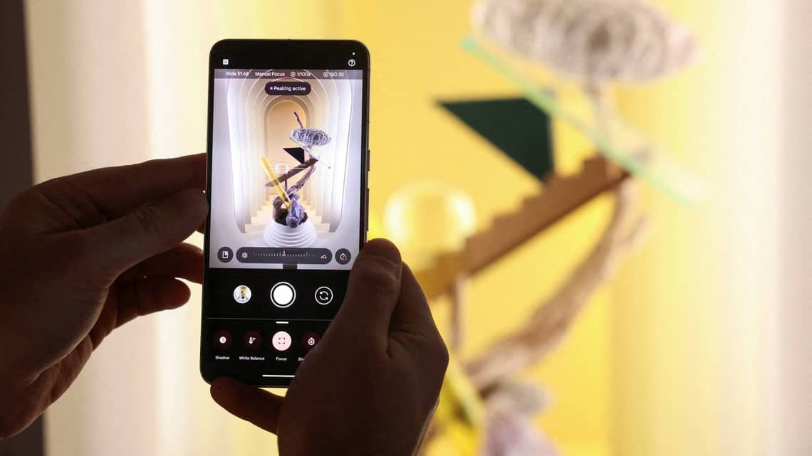 FILE PHOTO: A Google employee demonstrates manual focus features of the new Google Pixel 8 Pro Phone in New York City, U.S., October 4, 2023.
