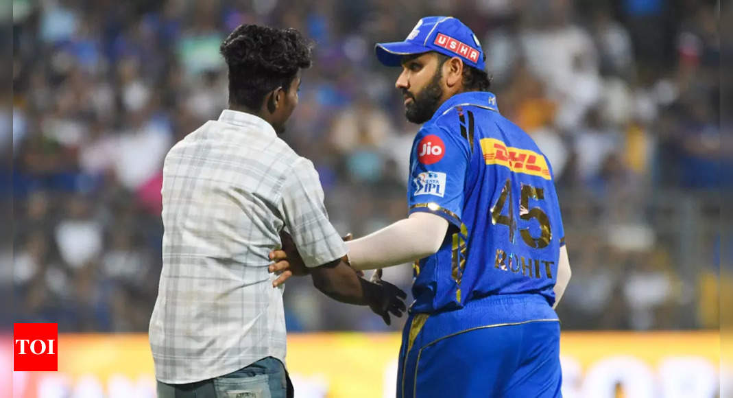 Watch: Fan invades field, scares Rohit Sharma during MI vs RR match | Cricket News – Times of India